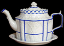 Image of a white felspathic tea pot trimmed in blue. (Private collection)